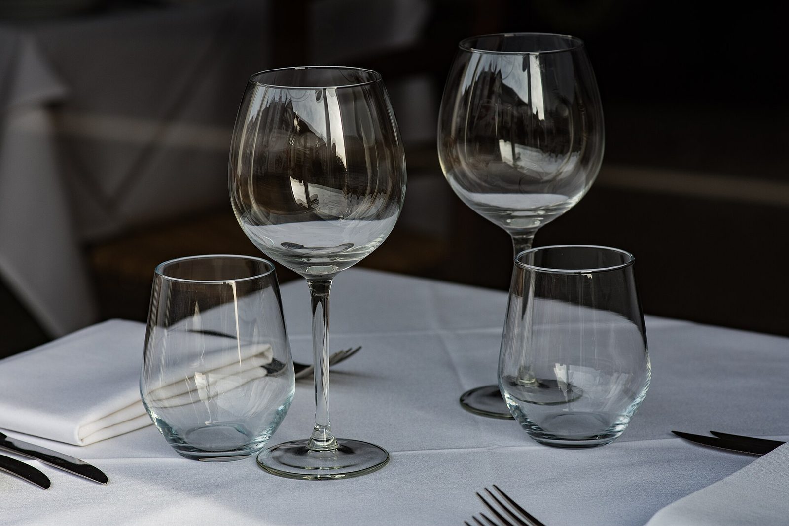 Vinglass og vannglass dekket på et bord med hvit duk